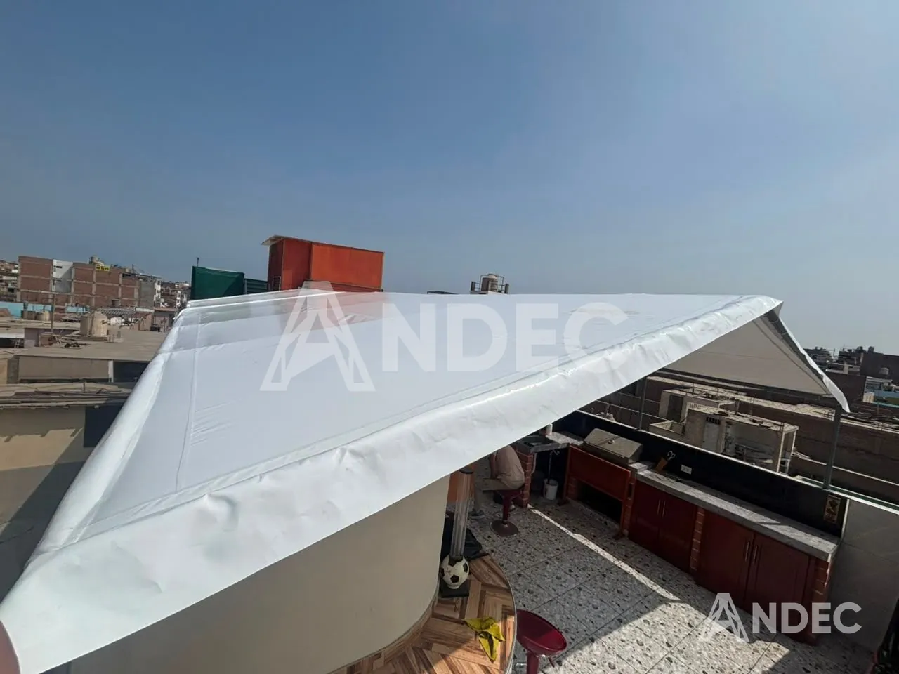 Vista lateral del toldo a dos aguas en lona PVC blanca sobre la terraza